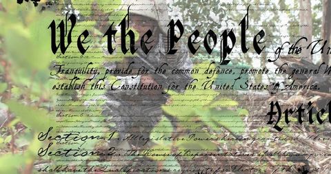 Crouching tactical operator in camouflage holding rifle with constitution script overlay