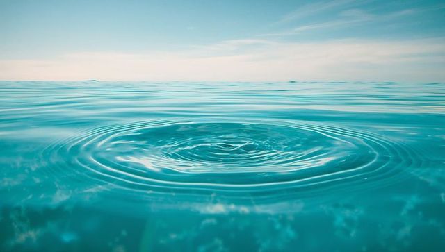 Calm ocean ripples under soft sky