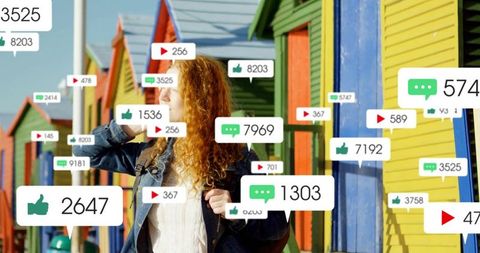 Redhead Woman Using Smartphone Surrounded by Social Media Icons