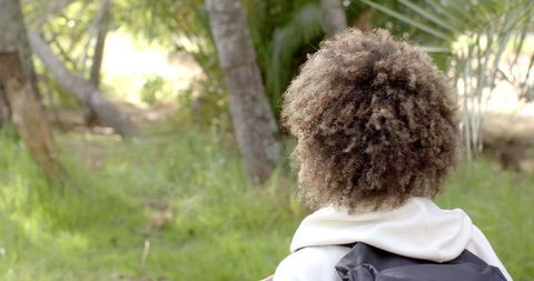 Young Woman Enjoying Nature with Relaxed Contemplation Outdoors