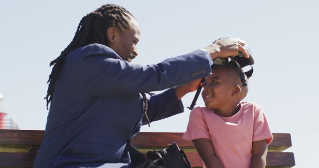 Father Putting Helmet on Young Son for Outdoor Activity - Download Free Stock Images Pikwizard.com