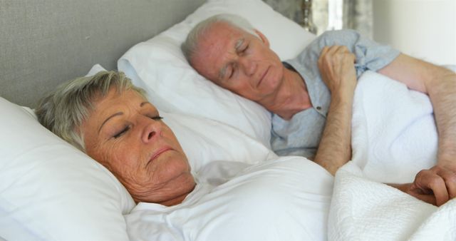 Senior couple sleeping in the bedroom at home - Download Free Stock Photos Pikwizard.com