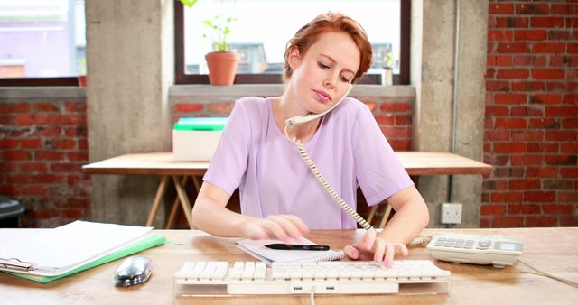 Multitasking Businesswoman on Phone and Using Computer in Office - Download Free Stock Images Pikwizard.com