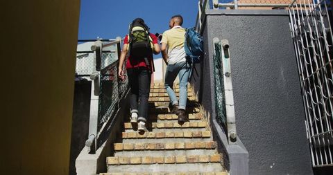 Friends Hiking Urban Steps with Backpacks Under Blue Sky - Download Free Stock Images Pikwizard.com
