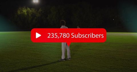 Standing athlete facing away on illuminated night sports field with red subscriber overlay