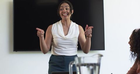 Energetic Businesswoman Presenting in Modern Office Meeting