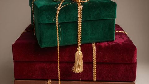 Stacking velvet gift boxes featuring emerald, burgundy, brown with gold tassel