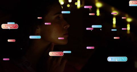 Person engaged with floating digital numbers in dark environment