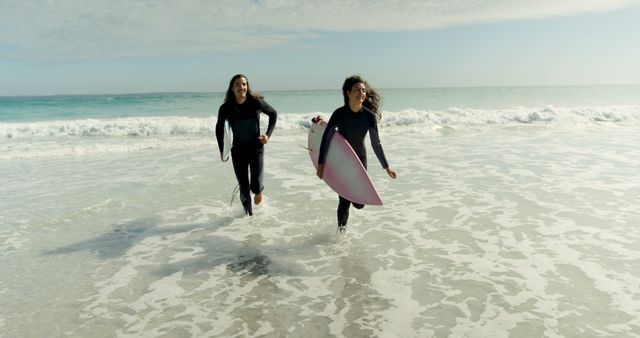 Two Surfers Running with Surfboards on Beach - Download Free Stock Images Pikwizard.com