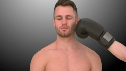 Man Calmly Receiving Punch from Boxing Glove