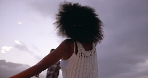 Young Couple Enjoying Beach Together with Sparklers