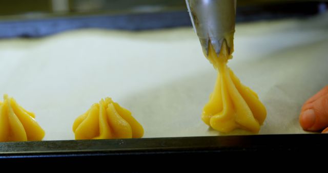 Precision Baking Hand Piping Fresh Dough onto Baking Sheet - Download Free Stock Images Pikwizard.com