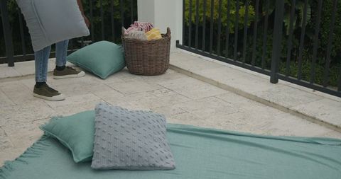 Cozy Patio Relaxation with Cushions and Essentials