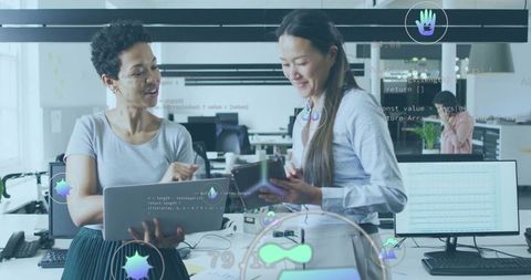 Women collaborating on code in modern tech office