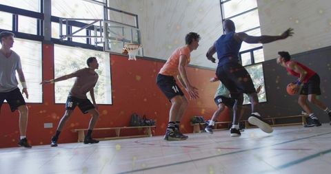 Explosive drive to basket: guard driving past defenders on indoor hardwood court