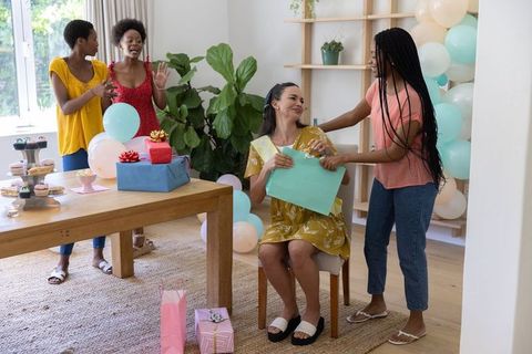Diverse Group Celebrating with Gifts and Balloons at Home Gathering