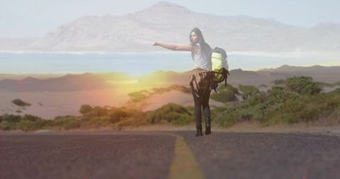 Hitchhiking Woman on Scenic Coastal Road at Sunrise