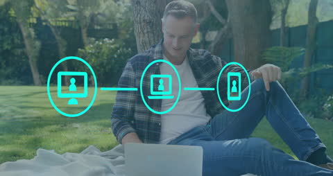 Man Using Laptop Outdoors with Digital Network Overlay