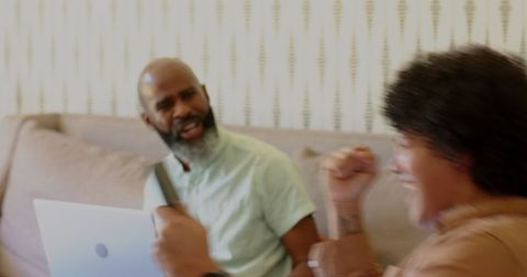 Smiling Friends Chatting with Smartphone and Laptop on Couch