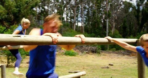 Energetic individuals navigating outdoor obstacle course