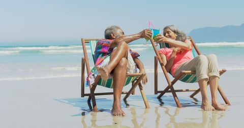 Senior African American Couple Enjoying Drinks on Beach Loungers - Download Free Stock Images Pikwizard.com