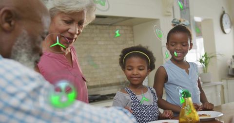 Multigenerational family interacting with augmented reality during breakfast preparation