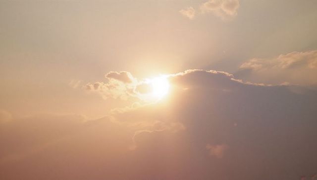 Radiant Sun Among Clouds During Golden Hour Capture