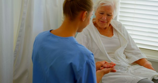 Caucasian female doctor consoling senior woman in a comfortable home - Download Free Stock Photos Pikwizard.com