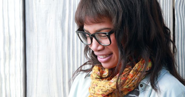 Smiling Young Woman with Glasses and Scarf Against Wooden Background - Download Free Stock Images Pikwizard.com