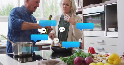 Senior couple cooking together in modern kitchen with digital chat bubbles overlay