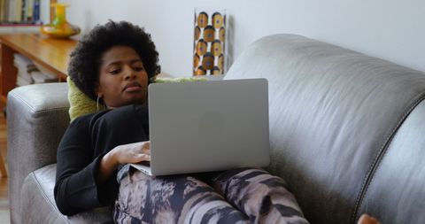 relaxed african american woman using laptop on sofa at home - Download Free Stock Images Pikwizard.com