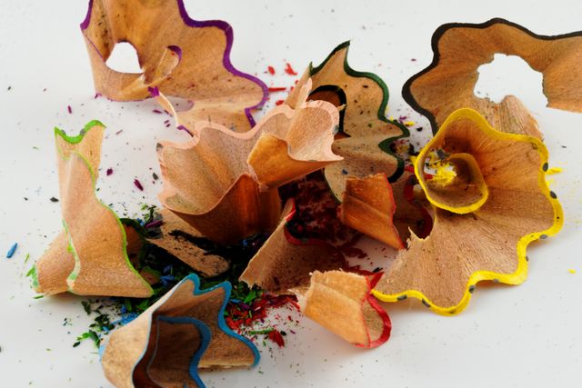 Colorful Pencil Shavings Close-Up on White Surface - Download Free Stock Images Pikwizard.com