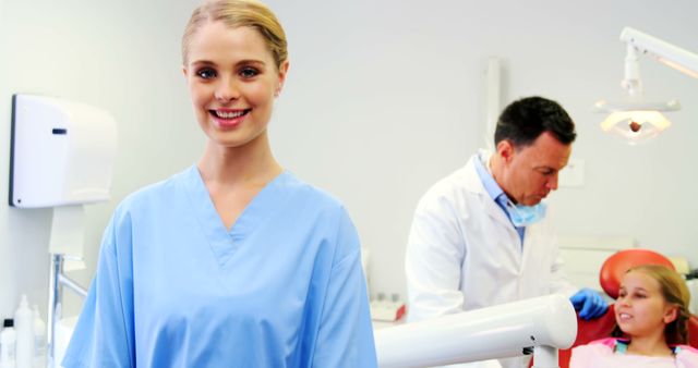 Smiling Dental Assistant Comforting Young Patient During Checkup - Download Free Stock Images Pikwizard.com