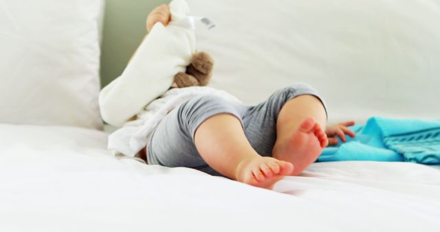 Cute Baby Lying on Bed Playing with Stuffed Animal - Download Free Stock Images Pikwizard.com