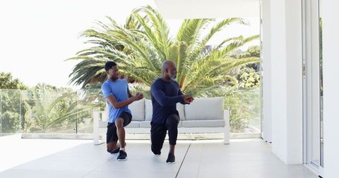 Workout Partners Performing Lunges on Modern Terrace
