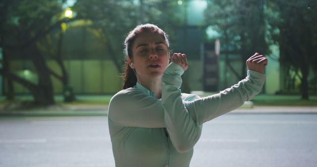 Young Woman Stretching Before Nighttime Run in Urban Area - Download Free Stock Images Pikwizard.com