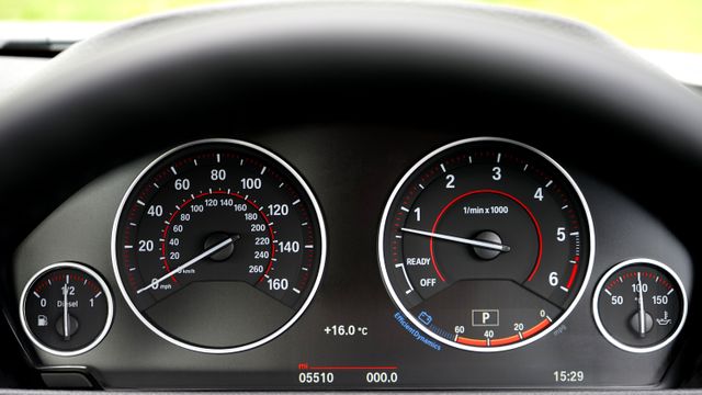 Close-up of a car dashboard showing speedometer and tachometer with clear display of gauges and readings. Ideal for use in automotive articles, vehicle reviews, driving tutorials, or car maintenance guides.