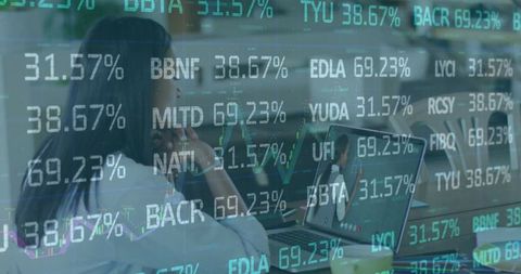 Focusing woman analyzing real-time stock data on laptop in modern office