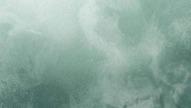 Teal-green nebula dust abstract background with misty swirls and speckled texture