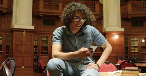 Young Adult Engaged with Mobile Technology in Traditional Library