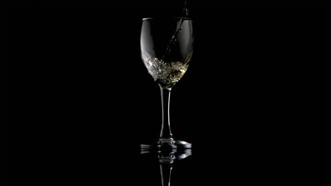 Slow Motion Water Pouring into Elegant Wine Glass with Reflection