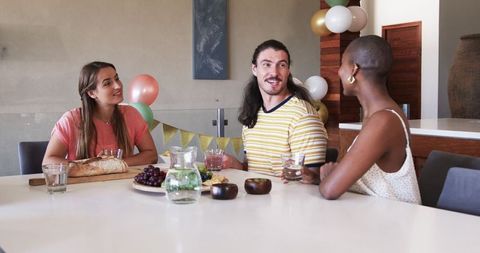 Friends Socializing at Home over a Table of Food
