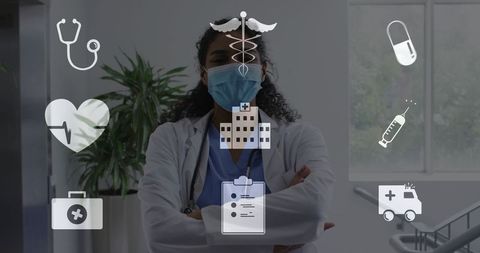 Confident female doctor standing arms crossed wearing mask and stethoscope in corridor