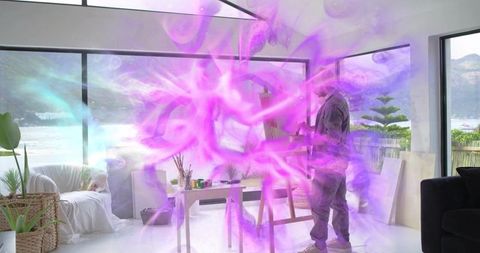 Artist painting on canvas in bright waterfront studio with purple-pink light swirls