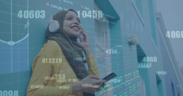 Muslim woman enjoying music with overlay of financial data charts - Download Free Stock Images Pikwizard.com