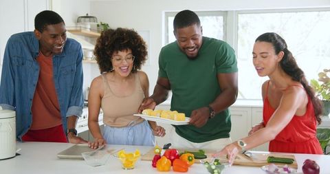Friends Preparing Colorful Vegetables in Modern Kitchen