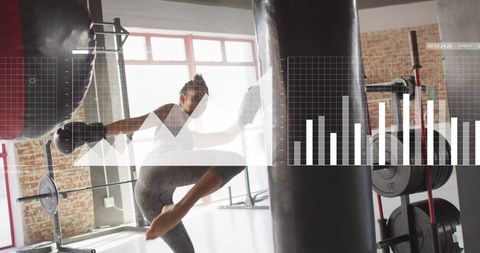 Female athlete punching heavy bag during intense gym session