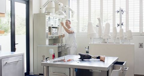 Technician crafting prosthetic in modern workshop