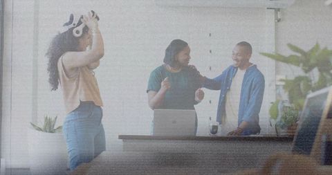 Team testing vr headset in modern office celebrating tech demo and collaborative teamwork