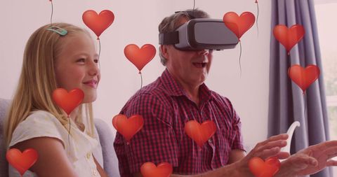 Grandfather Using VR Headset with Granddaughter and Virtual Hearts